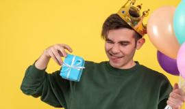 front-view-handsome-young-man-with-crown-holding-balloons-gift-yellow_179666-10324.jpg