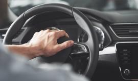 man-s-big-hands-steering-wheel-while-driving-car.jpg