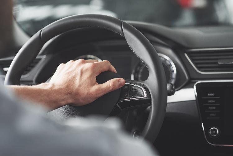 man-s-big-hands-steering-wheel-while-driving-car.jpg