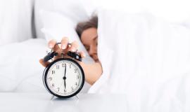 woman-turning-off-the-alarm-clock.jpg