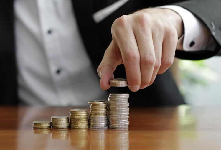 closeup-shot-businessman-s-hands-counting-stacks-coins-after-business-success.jpg