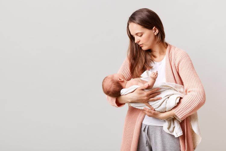 beautiful-dark-haired-mother-with-newborn-baby-in-hands (1).jpg