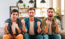 excited-young-men-sitting-sofa-cheering-while-watching-match-television_23-2148160255.jpg