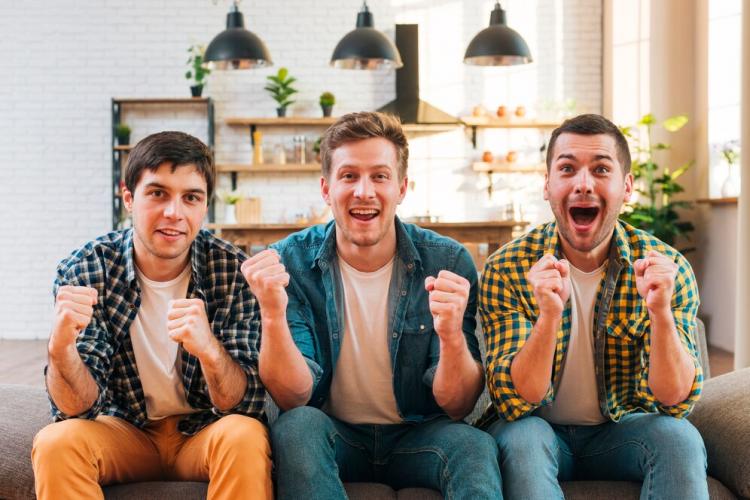 excited-young-men-sitting-sofa-cheering-while-watching-match-television_23-2148160255.jpg