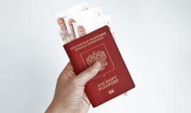 hand-holding-russian-passport-with-5000-rubles-banknotes.jpg