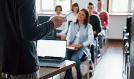 everyone-is-smiling-and-listens-group-of-people-at-business-conference-in-modern-classroom-at-daytime.jpg