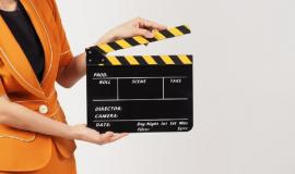 woman-s-body-part-hold-black-clapperboard-movie-slate-she-wears-yellow-mustard-suit-white-background_335640-4147.jpg