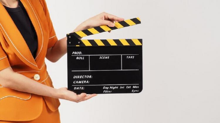 woman-s-body-part-hold-black-clapperboard-movie-slate-she-wears-yellow-mustard-suit-white-background_335640-4147.jpg