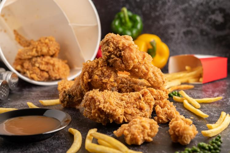 fried-chicken-and-french-fries-on-black-cement-floor.jpg