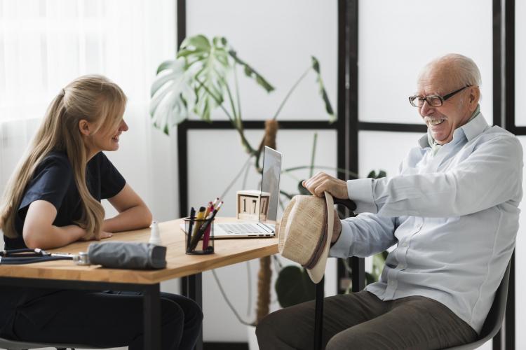 smiley-senior-man-nursing-home-with-nurse.jpg