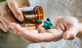 woman-s-hand-pours-the-medicine-pills-out-of-the-bottle.jpg