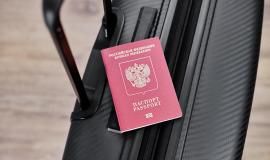 russian-passport-on-a-black-travel-suitcase-top-view-selective-background-emigration-of-russians-seeking-asylum.jpg