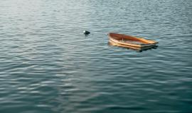 wooden-small-boat-sinking-on-a-calm-lake-in-pais-vasco-spain.jpg