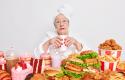 surprised-elderly-lady-with-red-lipstick-has-imbalancd-nutrition-eats-different-tasty-junk-food-drinks-cocktail-containing-much-sugar-dressed-in-domestic-clothes.jpg