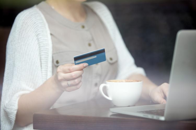 modern-woman-paying-online-with-credit-card-shot-through-window.jpg