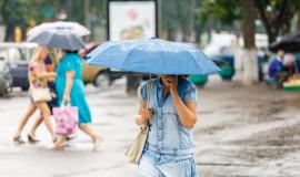 a-woman-is-holding-an-umbrella-during-heavy-rain-in-the-city-and-talking-on-the-phone_721890-362.jpg