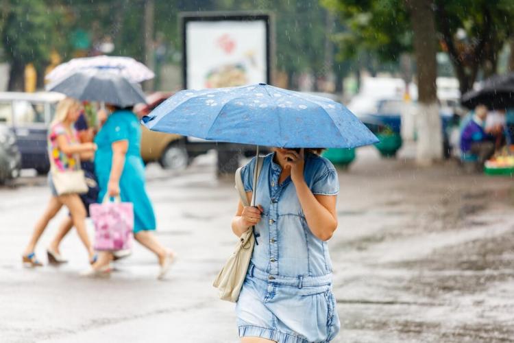 a-woman-is-holding-an-umbrella-during-heavy-rain-in-the-city-and-talking-on-the-phone_721890-362.jpg