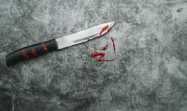 knife-with-artificial-blood-on-stone-desk.jpg