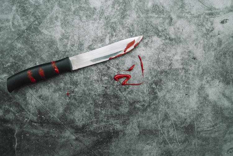 knife-with-artificial-blood-on-stone-desk.jpg