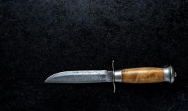 closeup-shot-small-sharp-knife-with-brown-handle-black-background_181624-9590.jpg