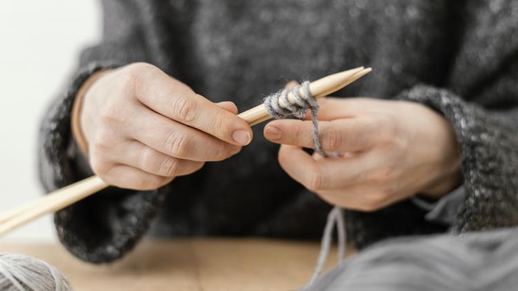 close-up-hands-holding-knitting-needles.jpg