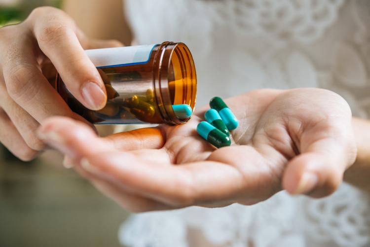 woman-s-hand-pours-the-medicine-pills-out-of-the-bottle (1).jpg