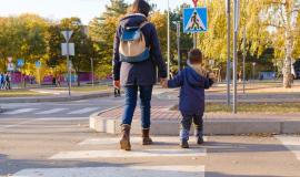 mom-and-child-cross-the-road-at-the-zebra-crossing_528985-1260.jpg