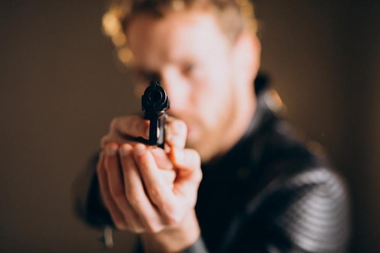 handsome-man-actor-posing-studio-with-weapon_1303-26967.jpg