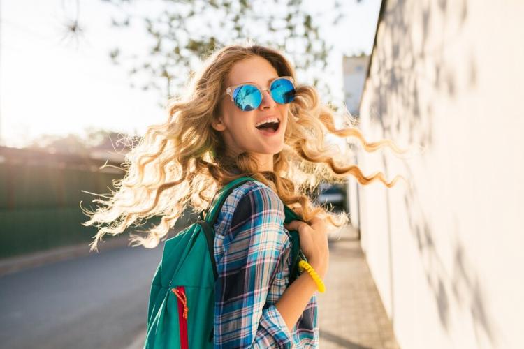 cool-stylish-smiling-happy-blond-woman-walking-street-with-backpack_285396-1627.jpg