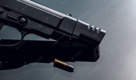 black-handgun-black-background-with-reflection-close-up_93675-105993.jpg