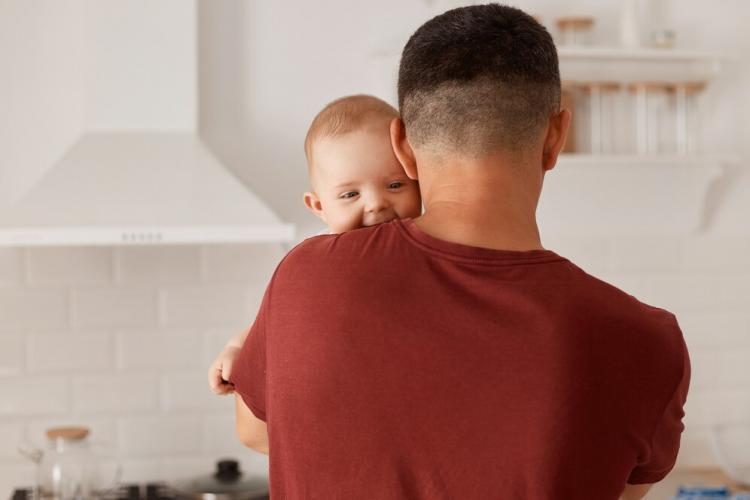 back-view-portrait-young-adult-caucasian-father-holding-son-daughter-cute-baby-looking-camera-mans-shoulder-posing-indoor-with-kitchen-set-background_176532-15592.jpg