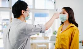 asia-male-receptionist-conducting-wear-protective-face-mask-use-infrared-thermometer-checker-temperature-gun-customer-s-forehead-before-enter-office-lifestyle-new-normal-after-corona-virus_7861-2609.jpg