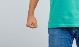 young-man-standing-with-clenched-fist-in-green-t-shirt-jeans-and-looking-angry-front-view (1).jpg