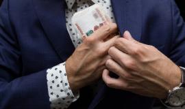 businessman-suit-puts-bundle-russian-money-his-pocket-concept-bribery_483938-25.jpg