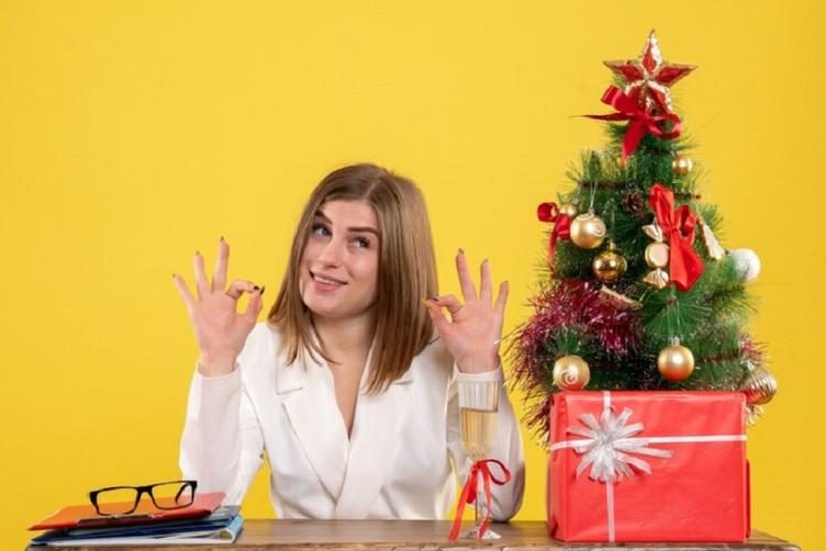 front-view-female-doctor-sitting-front-her-table-yellow-background-with-christmas-tree-gift-boxes_179666-10072.jpg