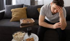 young-man-tired-sofa-home-sitting-junk-food_23-2149409577.jpg
