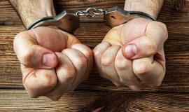 hands-handcuffs-dark-wooden_157402-1687.jpg