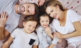 portrait-of-happy-family-lying-on-the-bed.jpg