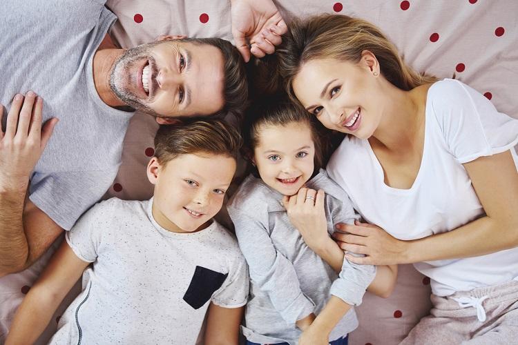 portrait-of-happy-family-lying-on-the-bed.jpg