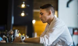 side-view-man-holding-glass-drink-restaurant_23-2147861974.jpg