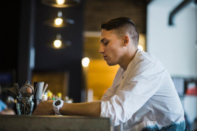 side-view-man-holding-glass-drink-restaurant_23-2147861974.jpg