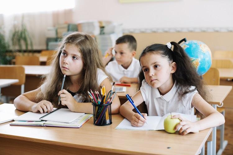 schoolchildren-studying-in-classroom-sitting-at-desks.jpg