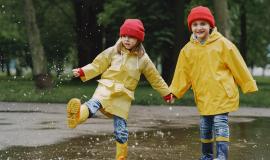 funny-kids-in-rain-boots-playing-with-paper-ship-by-a-puddle (1).jpg