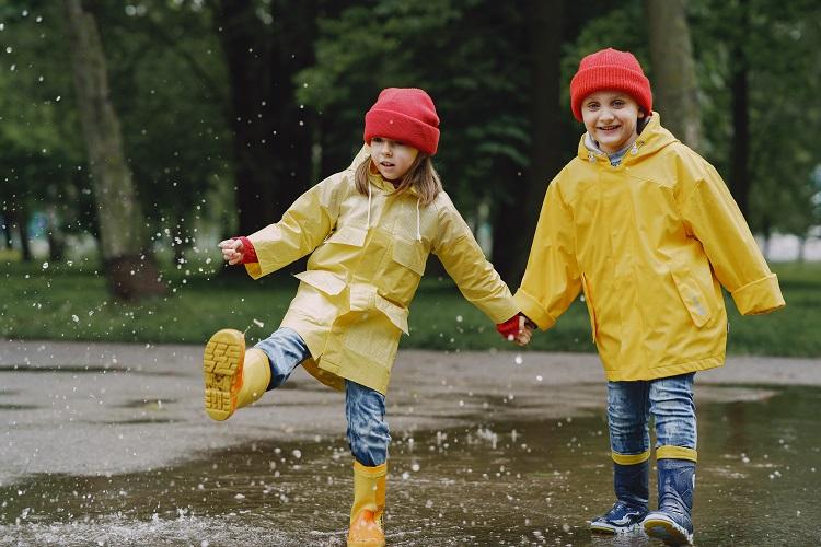 funny-kids-in-rain-boots-playing-with-paper-ship-by-a-puddle (1).jpg