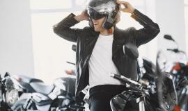 man-choosed-motorcycles-in-moto-shop-guy-in-a-black-jacket-man-in-a-helmet.jpg