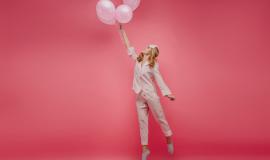 full-length-portrait-lovely-carefree-girl-standing-tip-toes-with-balloons-indoor-photo-curly-lady-pink-sleepwear-eyemask-jumping-with-smile_197531-21642.jpg