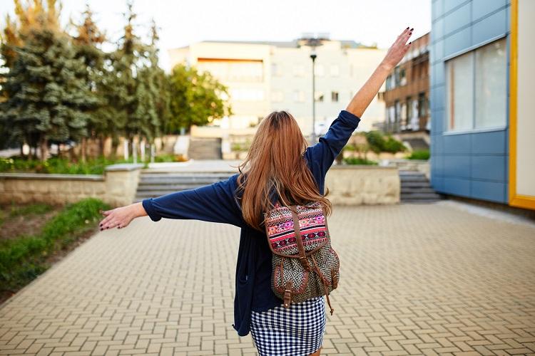 stdent-girl-with-a-backpack-walking-on-the-street.jpg