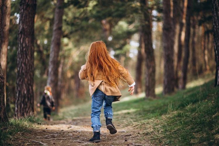 girl-with-her-little-brother-together-in-forest.jpg