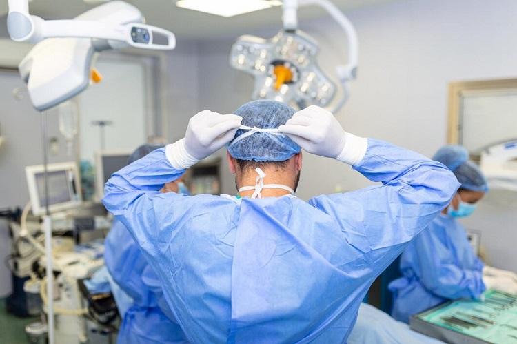 rear-view-of-male-surgeon-wearing-surgical-mask-in-operation-theater-at-hospital_657921-1145.jpg