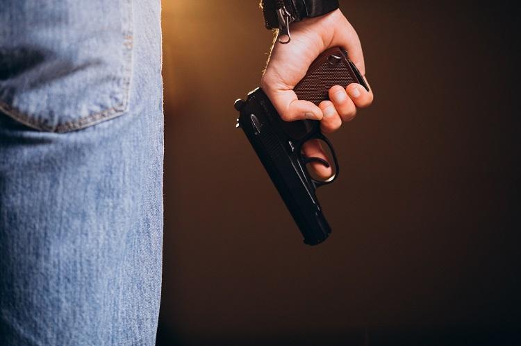 handsome-man-actor-posing-in-studio-with-weapon.jpg